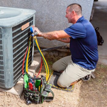 HVAC technician repairing air conditioner