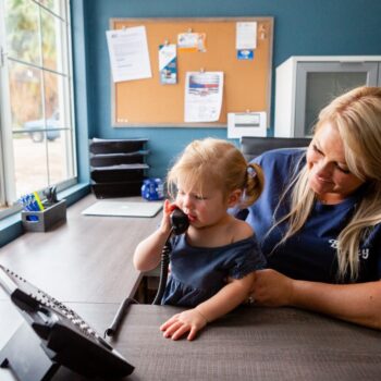 Child using phone at desk