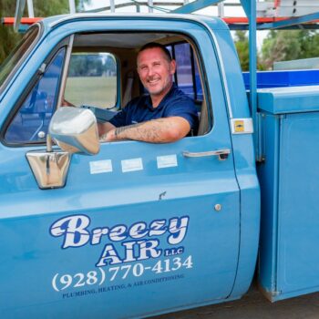 Smiling technician in service truck